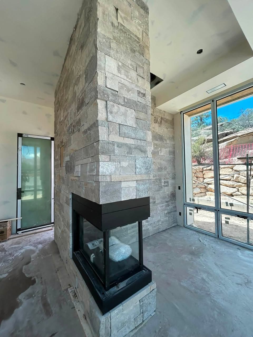 Natural stone installed around a three-sided fireplace